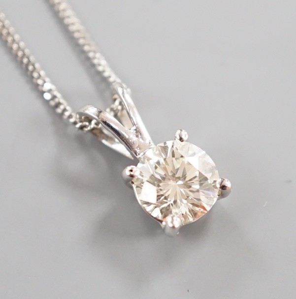 A modern 750 white metal and solitaire diamond set pendant, overall 14mm, on an 18ct white gold fine link chain, 44cm, gross weight 3.3 grams